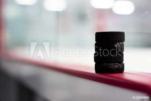Picture of Hockey pucks along the boards